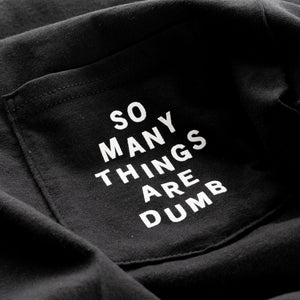 Detail of the original NO FUN® "So many things are dumb" pocket tee. This closeup image showcases the front pocket detail, and the white text that reads "So Many Things Are Dumb".