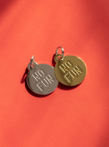 Both colours of the "No Fun®" Pet Tag Keyring against a red background.